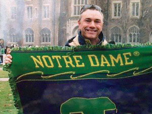 Man holding Notre Dame flag